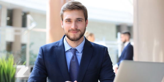 portrait-young-man-sitting-his-desk-office